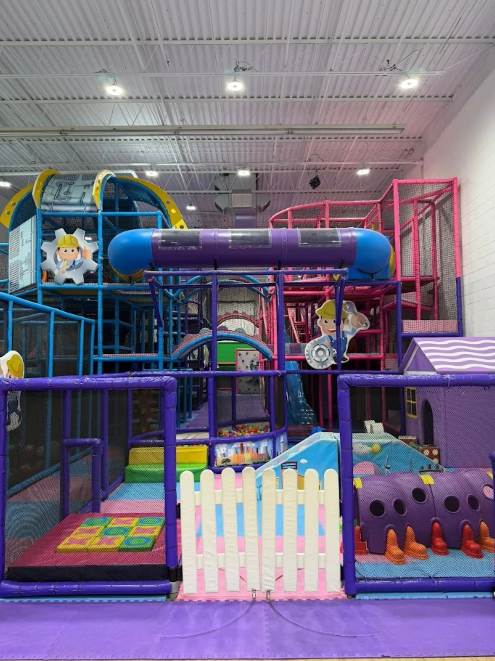 Multi-level indoor play structure with slides and tunnels at Fun Factory Play Café Pickering